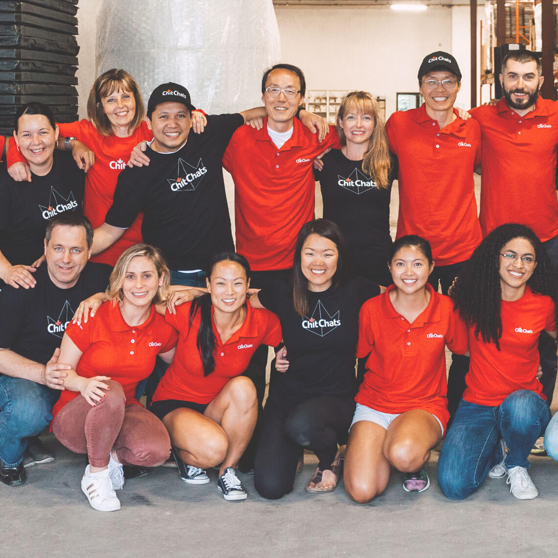 Chit Chats team wearing red and black company shirts